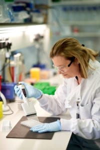 scientist with multichannel pipette